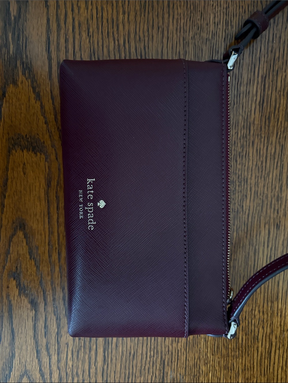 Kate Spade burgundy leather wristlet with gold logo